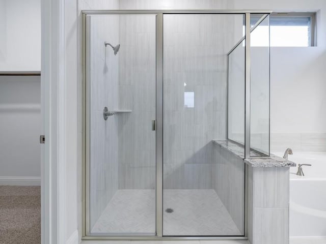 bathroom with separate shower and tub