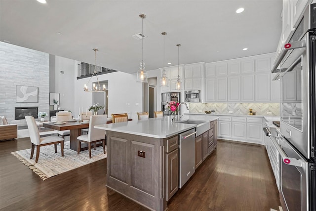 kitchen featuring tasteful backsplash, visible vents, light countertops, appliances with stainless steel finishes, and a sink