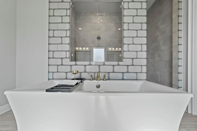 bathroom featuring a soaking tub and wood finished floors