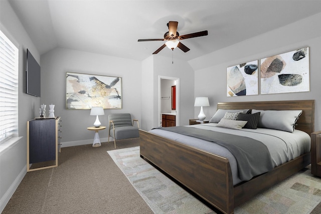 carpeted bedroom featuring connected bathroom, a ceiling fan, baseboards, and vaulted ceiling