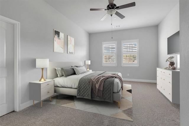 bedroom with ceiling fan, light colored carpet, visible vents, and baseboards