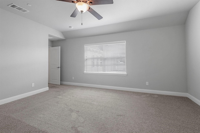 empty room with visible vents, light colored carpet, baseboards, and ceiling fan