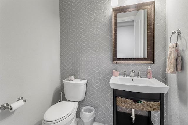 bathroom featuring toilet and vanity