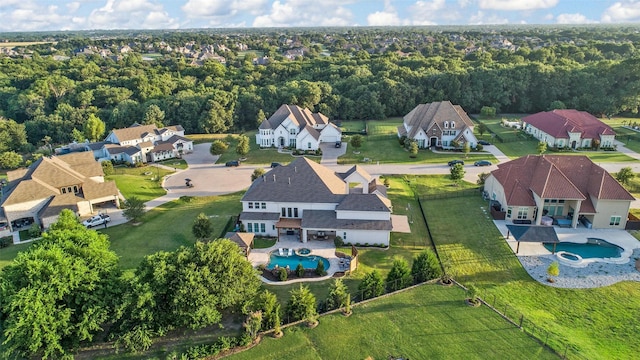 aerial view featuring a forest view and a residential view