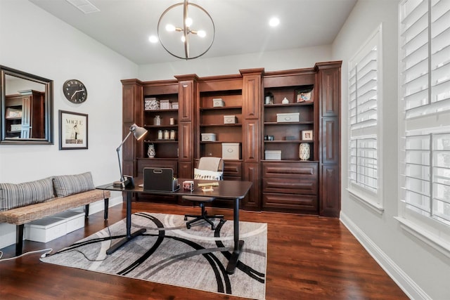 office with dark hardwood / wood-style floors and a chandelier