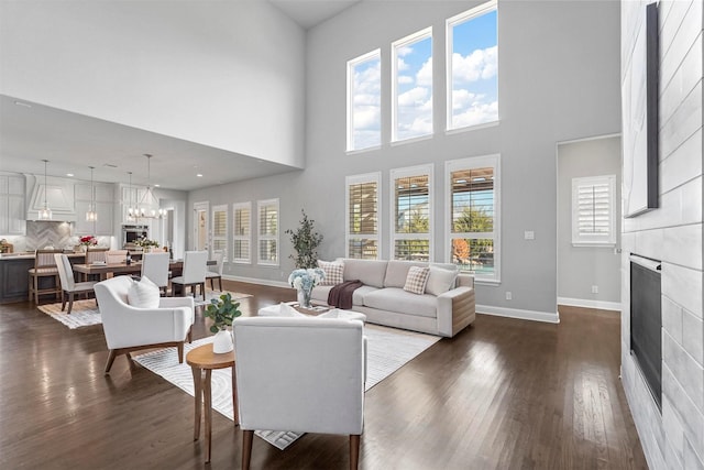 living area featuring a wealth of natural light, dark wood finished floors, and a fireplace