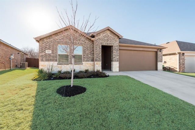 view of front facade with a garage, central AC unit, and a front lawn