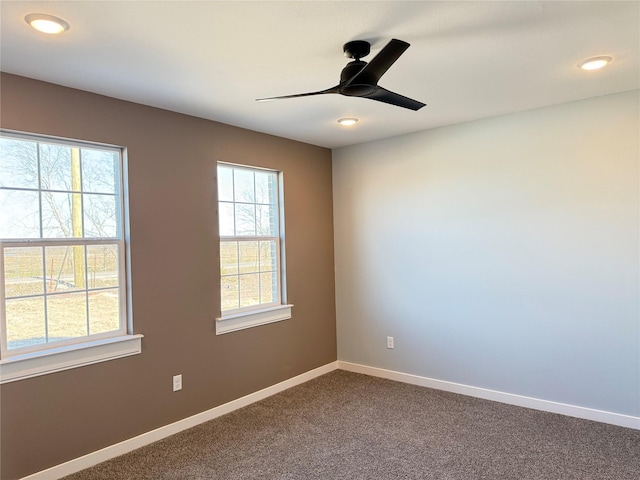 unfurnished room featuring ceiling fan and carpet flooring