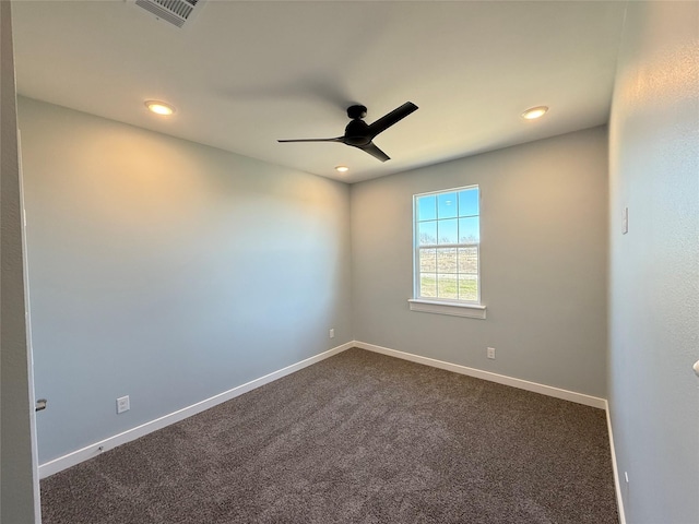 unfurnished room featuring dark carpet and ceiling fan