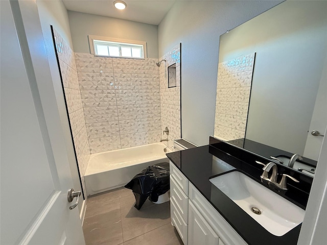 bathroom featuring tile patterned floors, vanity, and tiled shower / bath combo