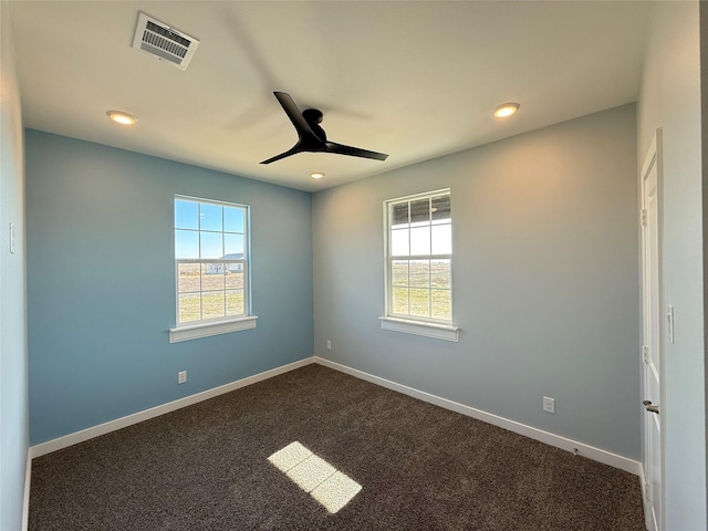 carpeted spare room featuring ceiling fan