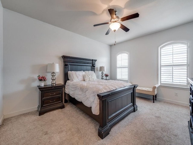 bedroom featuring light carpet and ceiling fan