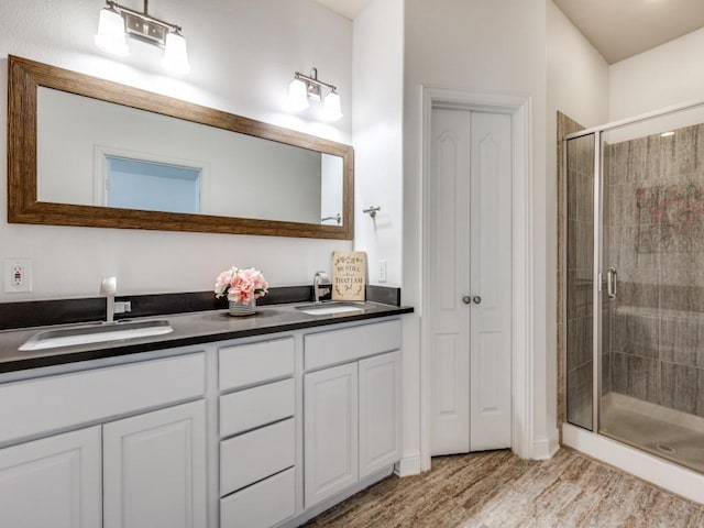 bathroom featuring vanity, hardwood / wood-style flooring, and walk in shower