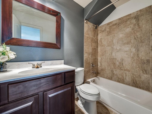 full bathroom featuring vanity, tiled shower / bath combo, and toilet