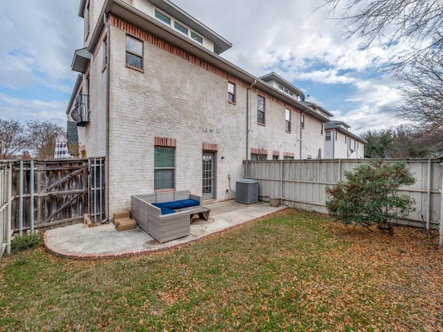 rear view of property featuring a yard, central AC, and a patio