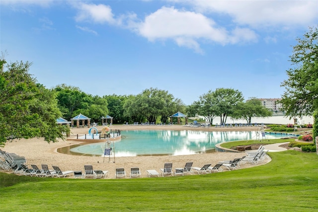 view of swimming pool with a yard