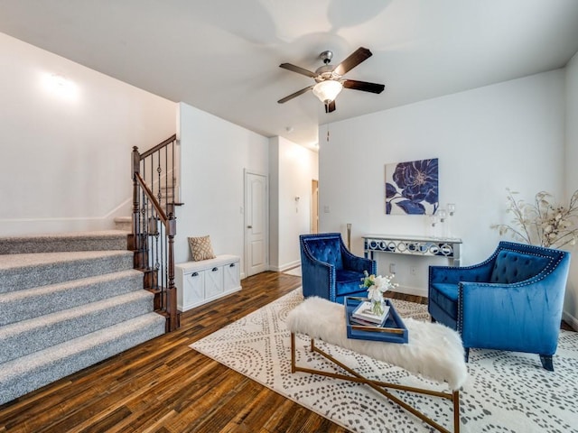 living area with dark wood-type flooring and ceiling fan