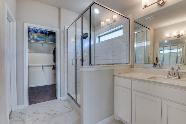 bathroom featuring vanity and a shower with door