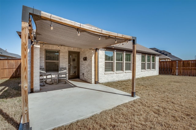 back of property featuring a yard and a patio