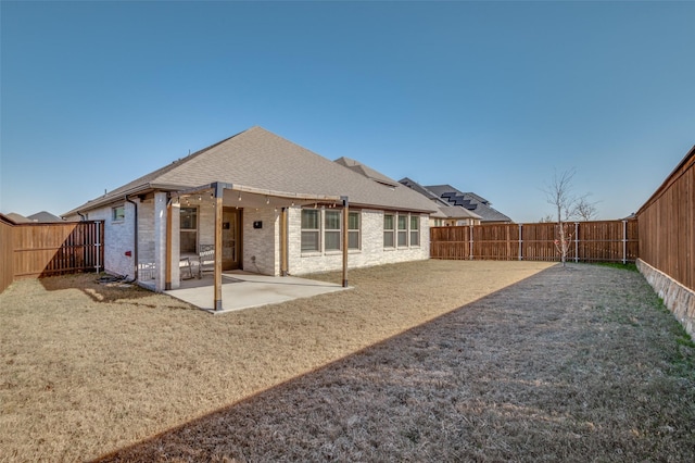 rear view of property featuring a yard and a patio