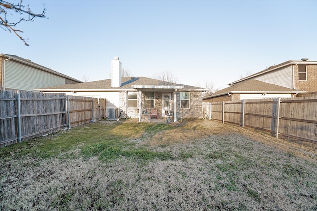 back of house featuring a yard, a patio area, and central air condition unit