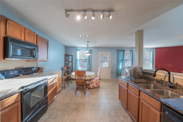 kitchen featuring rail lighting, sink, a textured ceiling, and black appliances