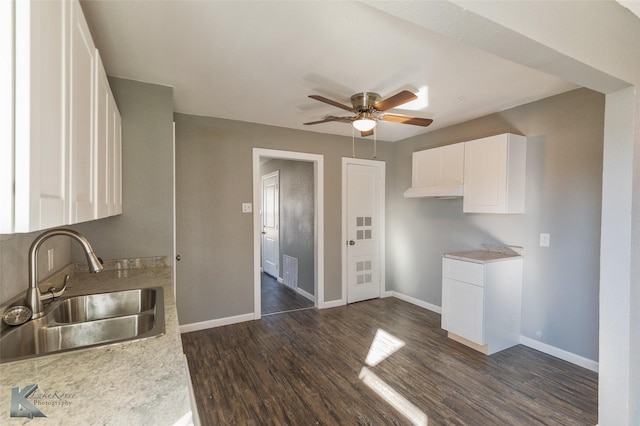 kitchen with ceiling fan, sink, white cabinets, and dark hardwood / wood-style floors