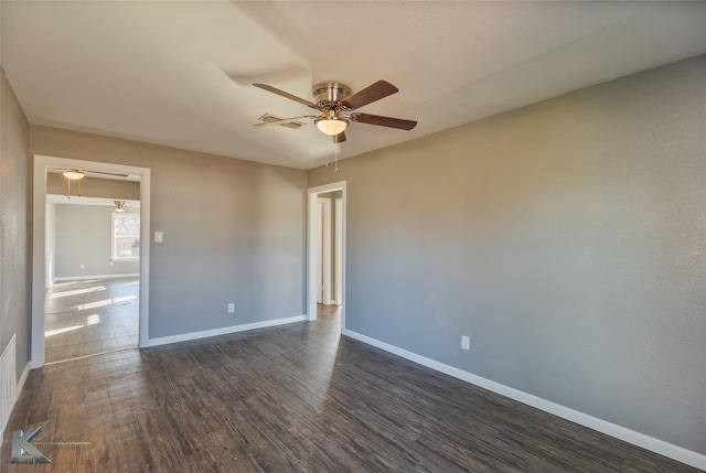 empty room featuring ceiling fan and dark hardwood / wood-style floors