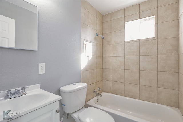 full bathroom with vanity, toilet, and tiled shower / bath combo