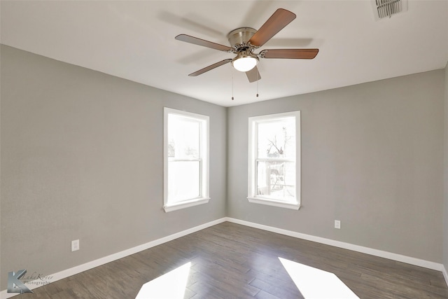 empty room with dark hardwood / wood-style floors and ceiling fan