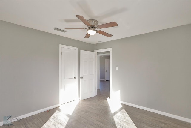 unfurnished bedroom featuring wood-type flooring and ceiling fan