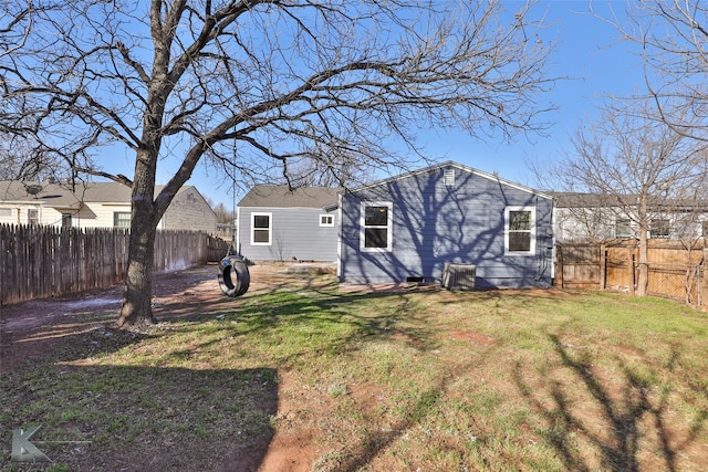 rear view of property with a yard