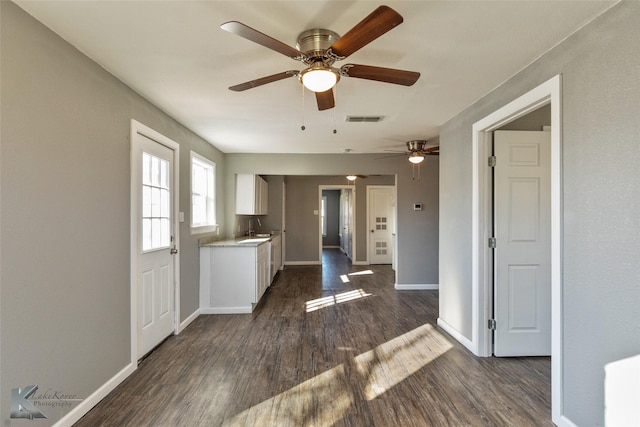 kitchen with dark hardwood / wood-style flooring, sink, and white cabinets