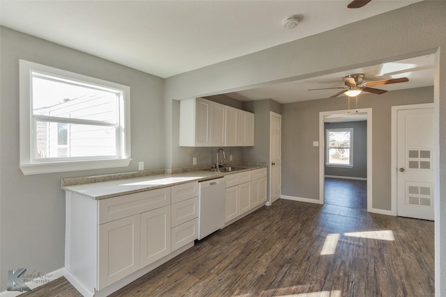 kitchen with sink, dark wood-type flooring, dishwasher, ceiling fan, and white cabinets