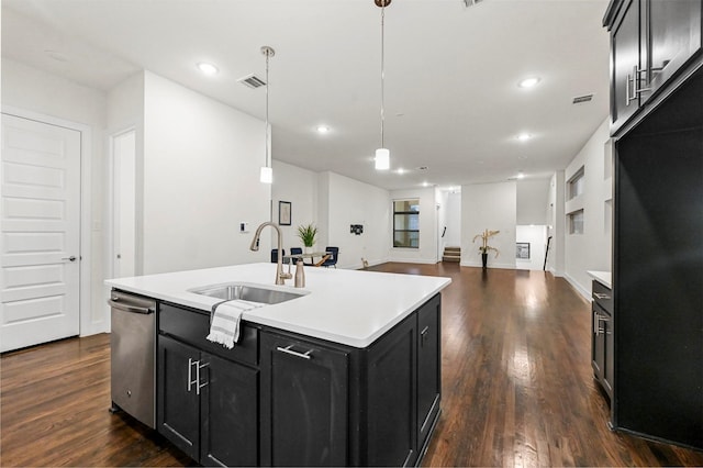 kitchen featuring sink, hanging light fixtures, a center island with sink, dark hardwood / wood-style flooring, and dishwasher