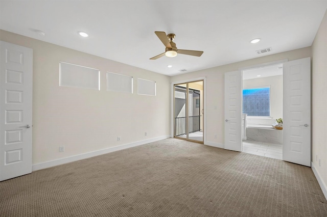 empty room featuring ceiling fan and light carpet