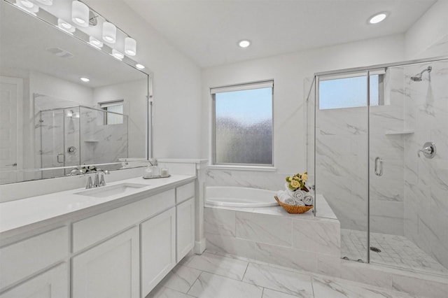 bathroom with vanity, a wealth of natural light, and plus walk in shower