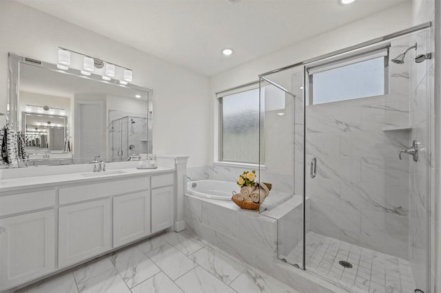 bathroom featuring vanity and separate shower and tub