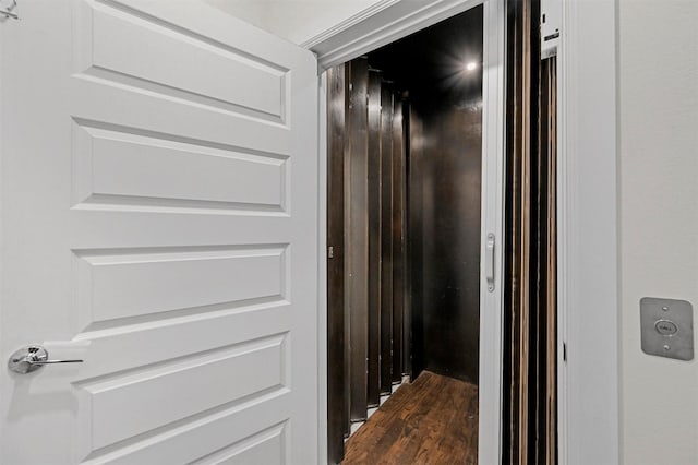 interior details featuring hardwood / wood-style floors and elevator