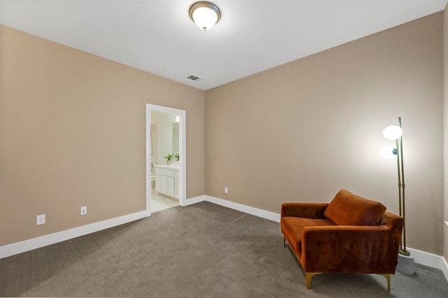 living area with dark colored carpet