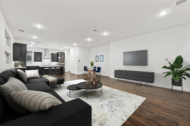 living room with dark hardwood / wood-style flooring