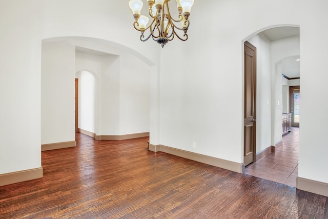 spare room with dark hardwood / wood-style flooring and crown molding