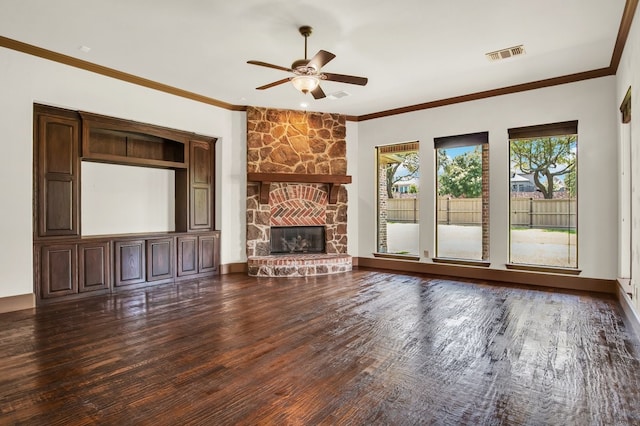 unfurnished living room featuring crown molding, ceiling fan, a fireplace, and dark hardwood / wood-style flooring