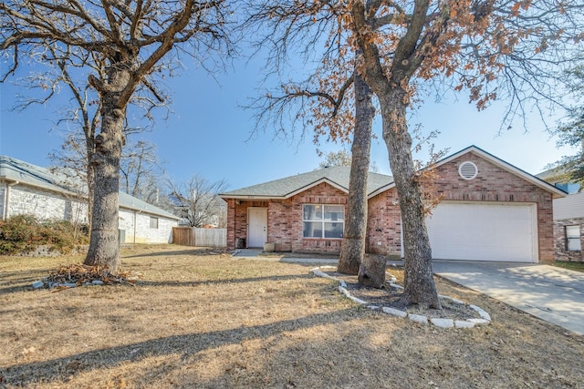 ranch-style home with a garage and a front yard