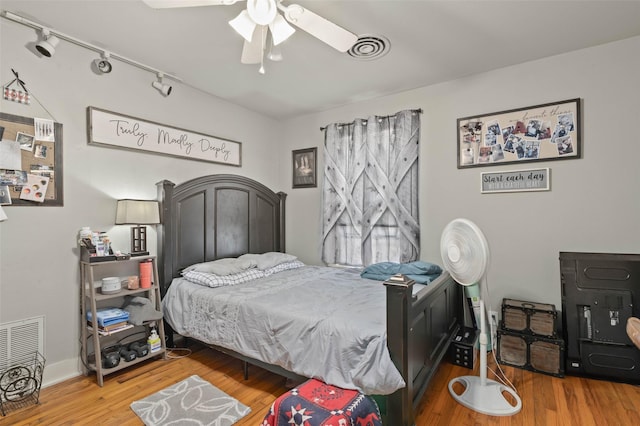 bedroom featuring hardwood / wood-style flooring and ceiling fan