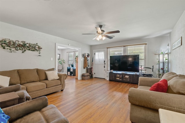 living room featuring light hardwood / wood-style floors and ceiling fan