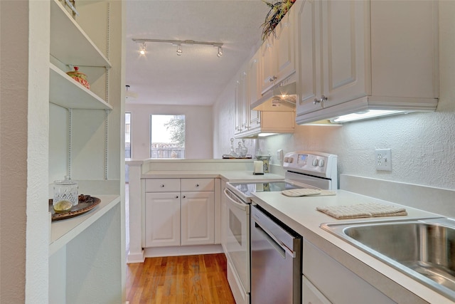 kitchen with sink, white cabinetry, light hardwood / wood-style flooring, track lighting, and white range with electric stovetop