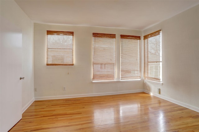 unfurnished room featuring a healthy amount of sunlight and light hardwood / wood-style flooring