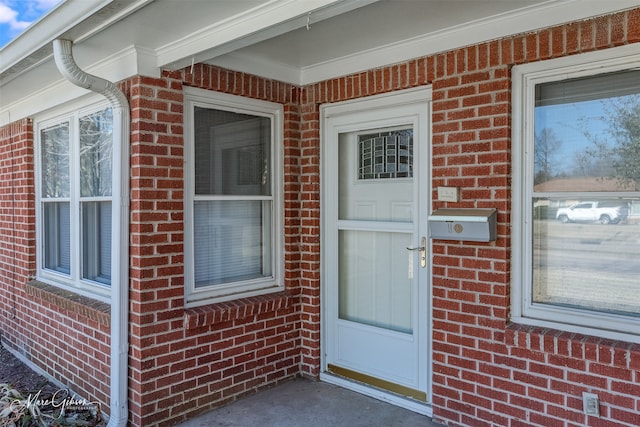 entrance to property with brick siding