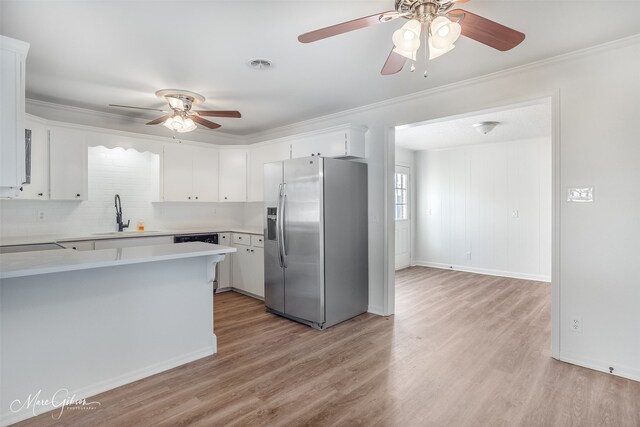 unfurnished room with ceiling fan, ornamental molding, and light wood-type flooring